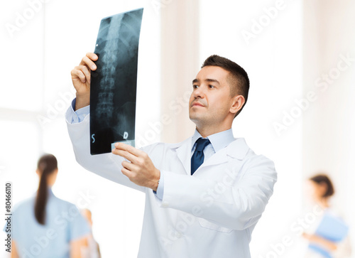 male doctor looking at x-ray in hospital photo