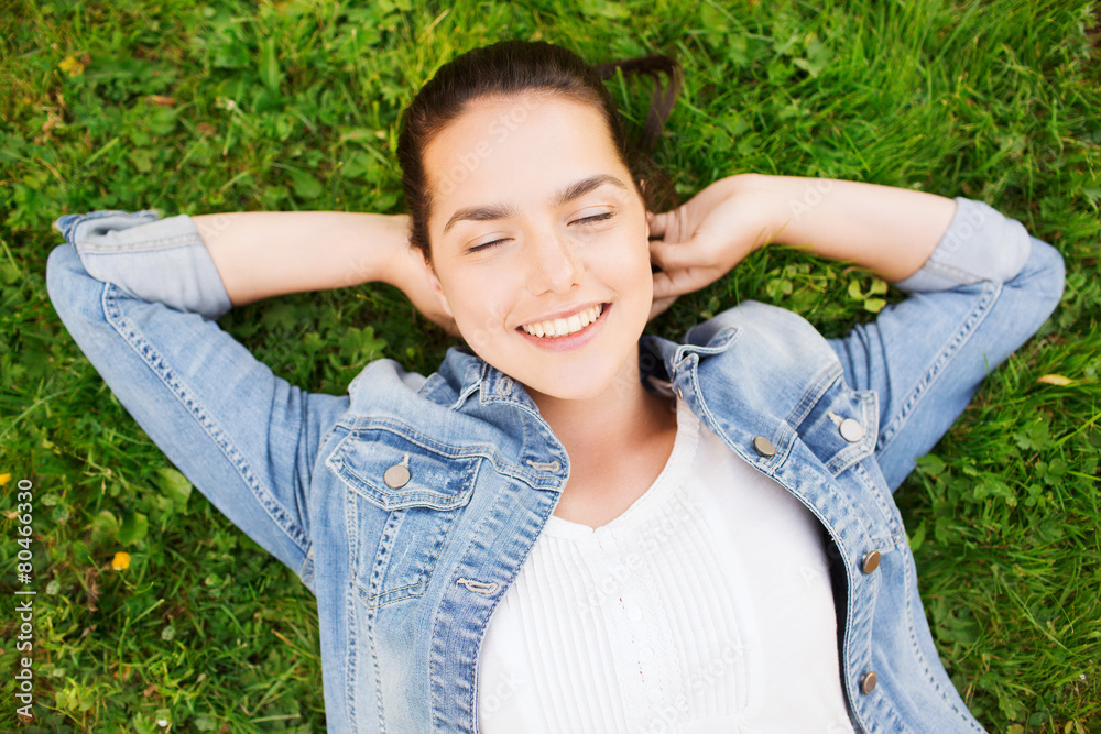 smiling young girl with closed eyes lying on grass smiling young girl with closed eyes lying on grass