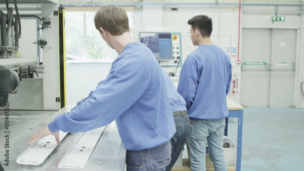 Mixed ethnicity team of machine operators in a factory