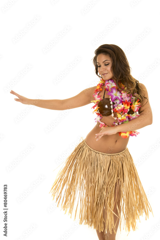 Foto de Hawaiian woman in grass skirt and coconut bra dancing do Stock