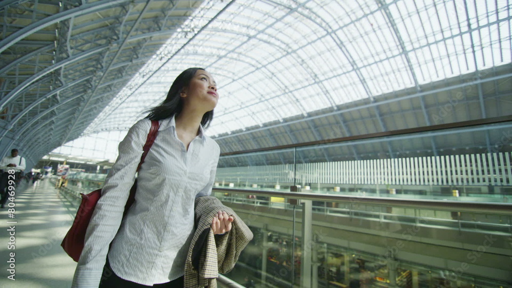 Beautiful woman traveling alone walks through iconic London railway station Beautiful woman traveling alone walks through iconic London railway station