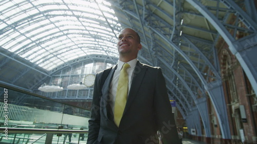 Wallpaper Mural Attractive cheerful businessman walking through St. Pancras railway station in L Torontodigital.ca