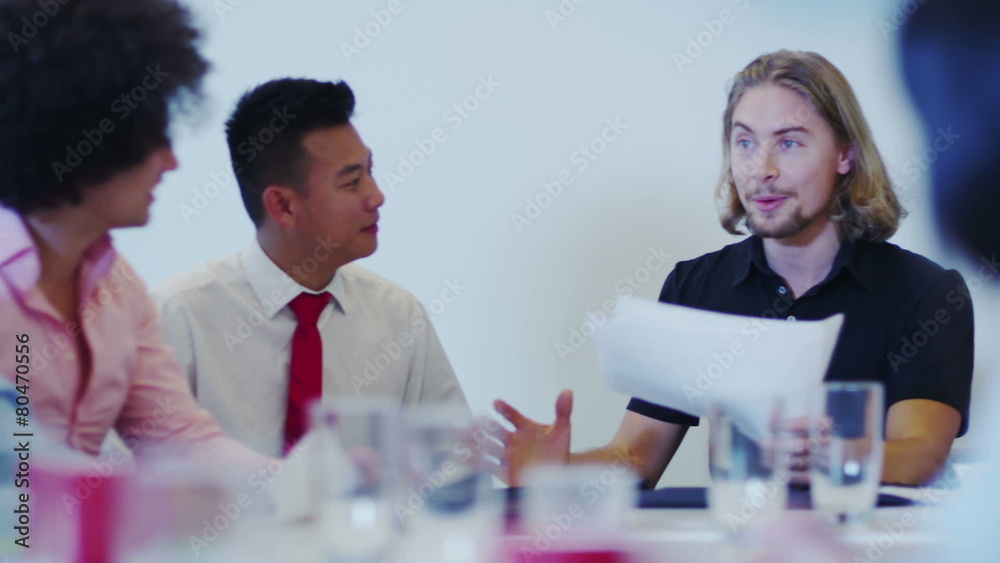 Attractive young mixed ethnicity business team in a boardroom meeting. Attractive young mixed ethnicity business team in a boardroom meeting.