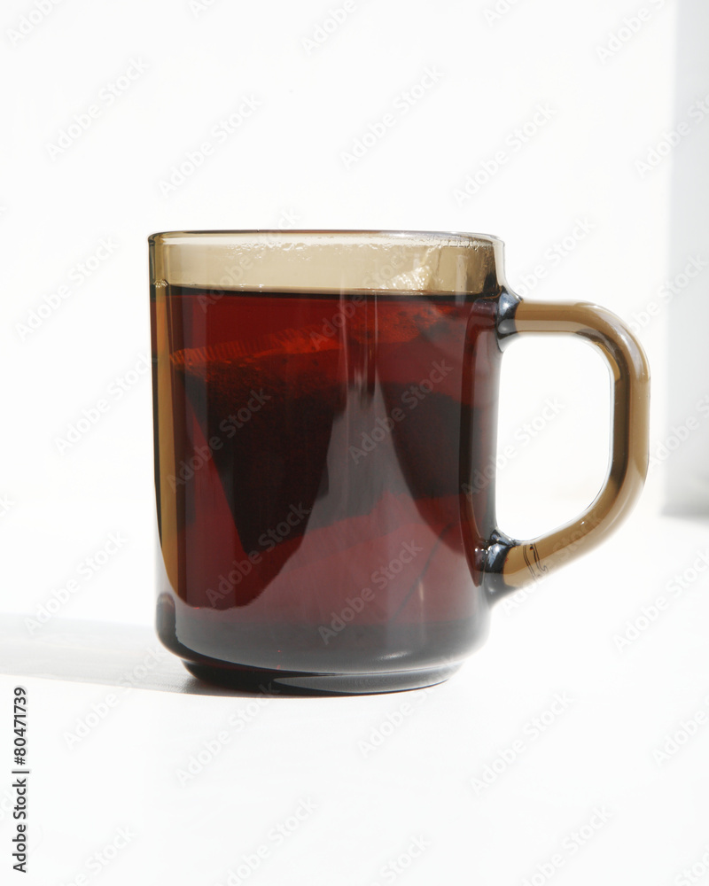 A cup of tea on the windowsill in the sunlight. A cup of tea on the windowsill in the sunlight.