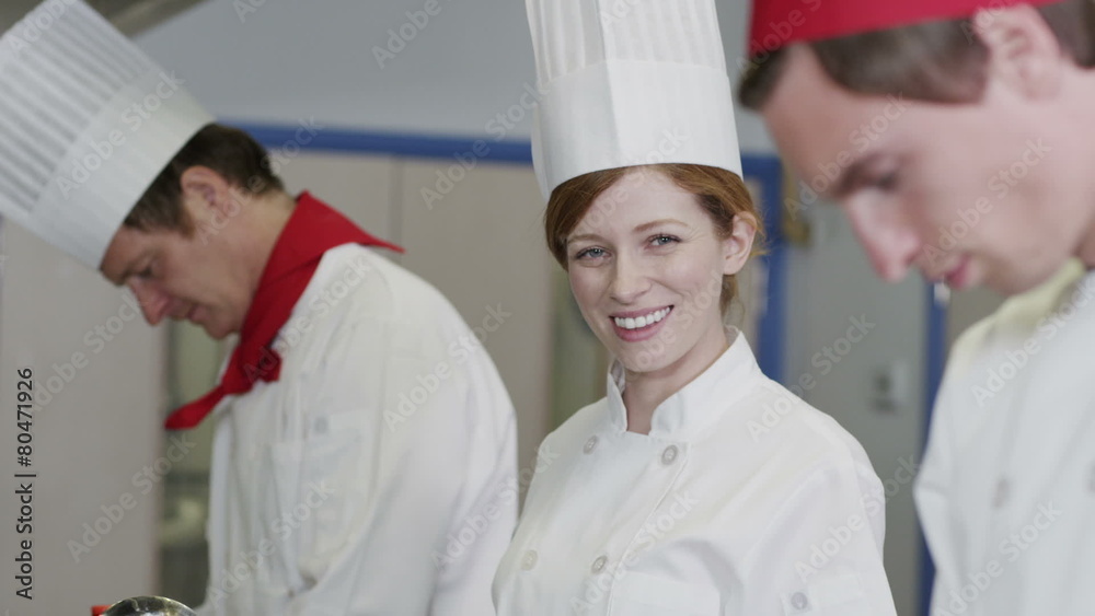 Portrait of attractive young female chef in commercial kitchen. Portrait of attractive young female chef in commercial kitchen.