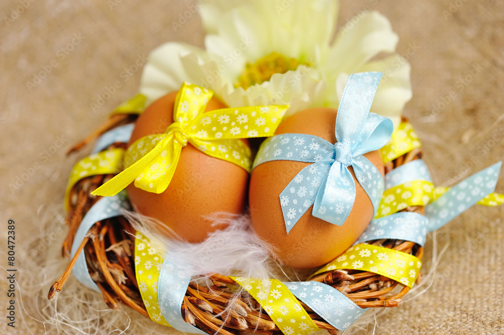 Easter eggs in the nest on a burlap Easter eggs in the nest on a burlap