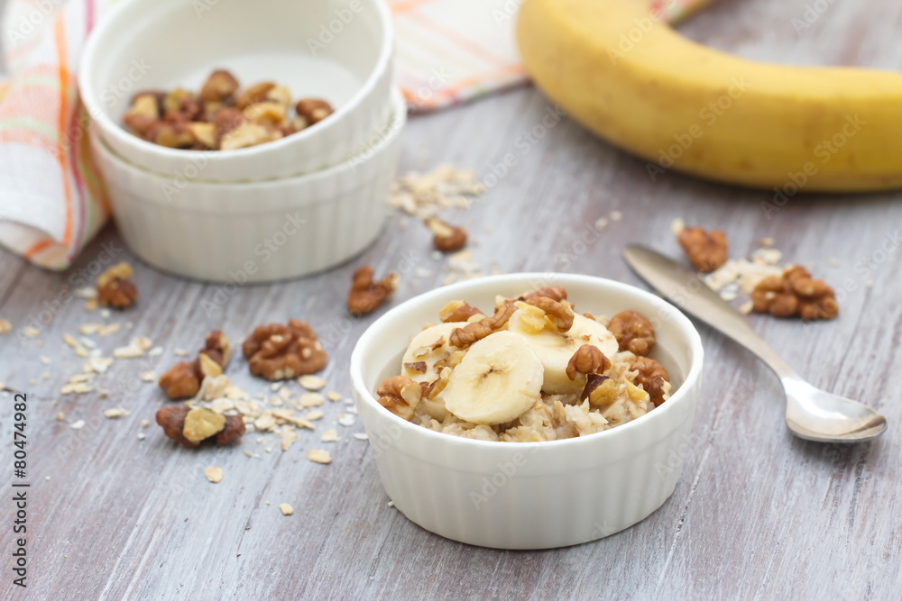 Oatmeal with banana, honey and walnuts for breakfast Oatmeal with banana, honey and walnuts for breakfast