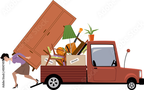 Woman relocating, unloading a truck full of furniture