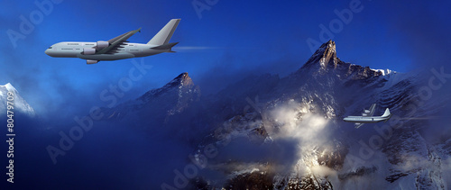 large aircraft and small plane on a background of high mountains