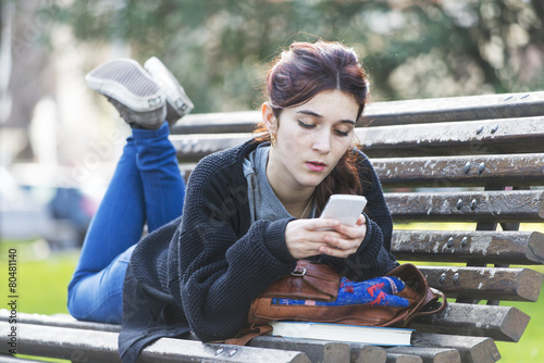 Girl reading message on phone, adolescense lifestile concept, ou