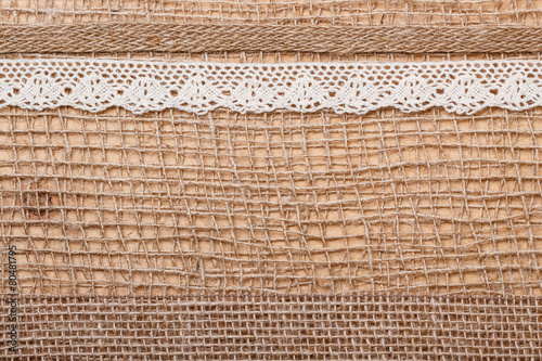 Lace ribbon on burlap cloth background