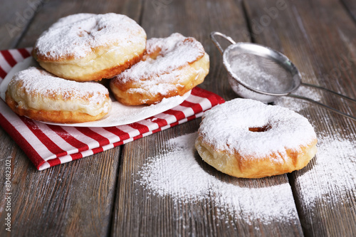 Delicious donuts with icing and powdered sugar