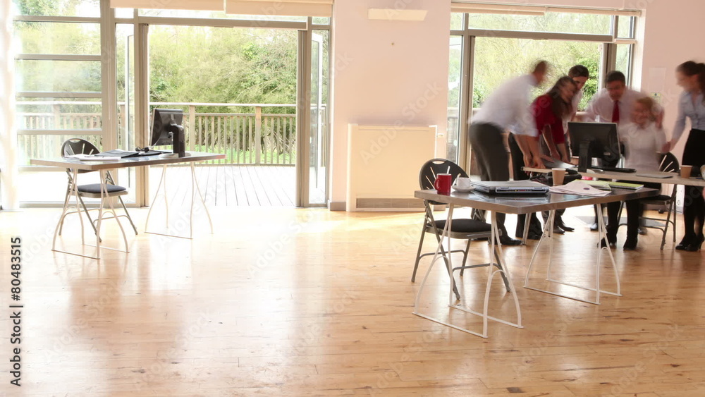 Time lapse of diverse business group at work in a busy office Time lapse of diverse business group at work in a busy office