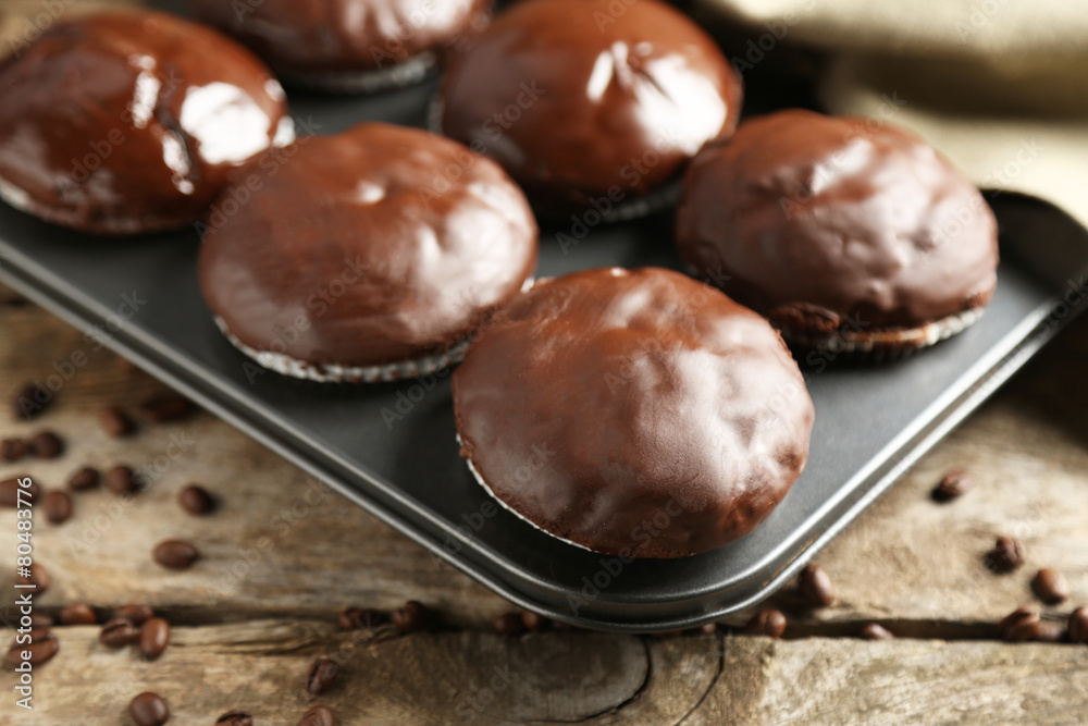 Tasty homemade chocolate muffins on wooden table