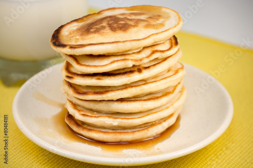 Hot pancakes with maple syrup and milk