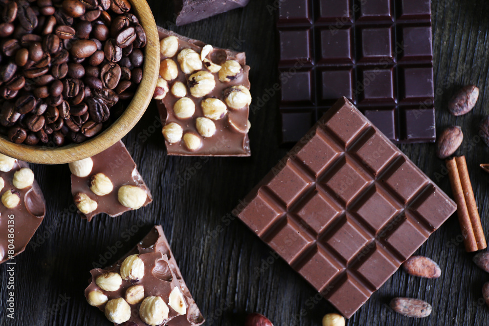 Set of chocolate with nuts on wooden table, top view Set of chocolate with nuts on wooden table, top view