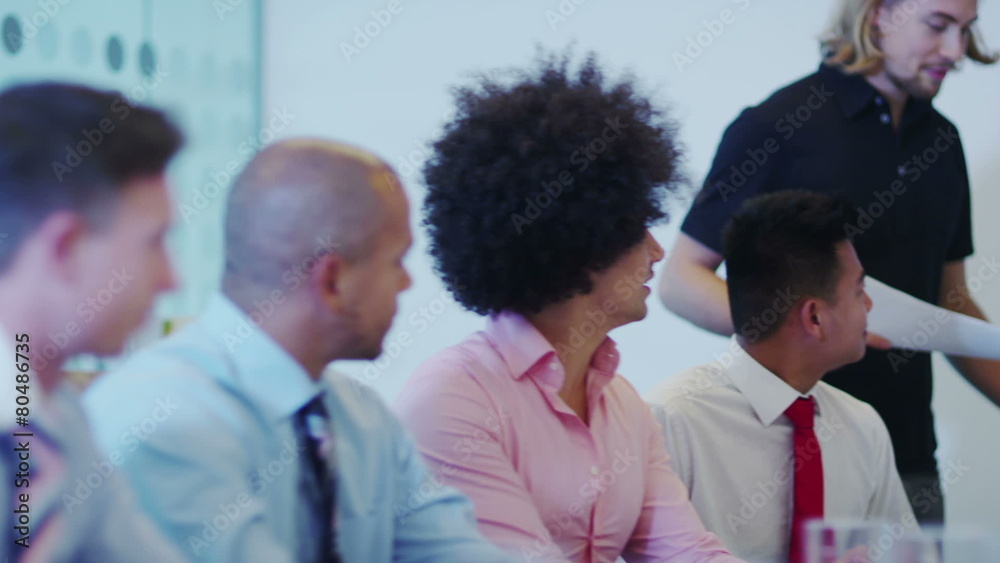Attractive young mixed ethnicity business team in a boardroom meeting. Attractive young mixed ethnicity business team in a boardroom meeting.