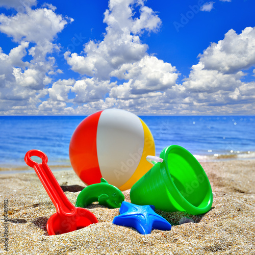 Fototapeta Naklejka Na Ścianę i Meble -  Baby Toys on beach sand