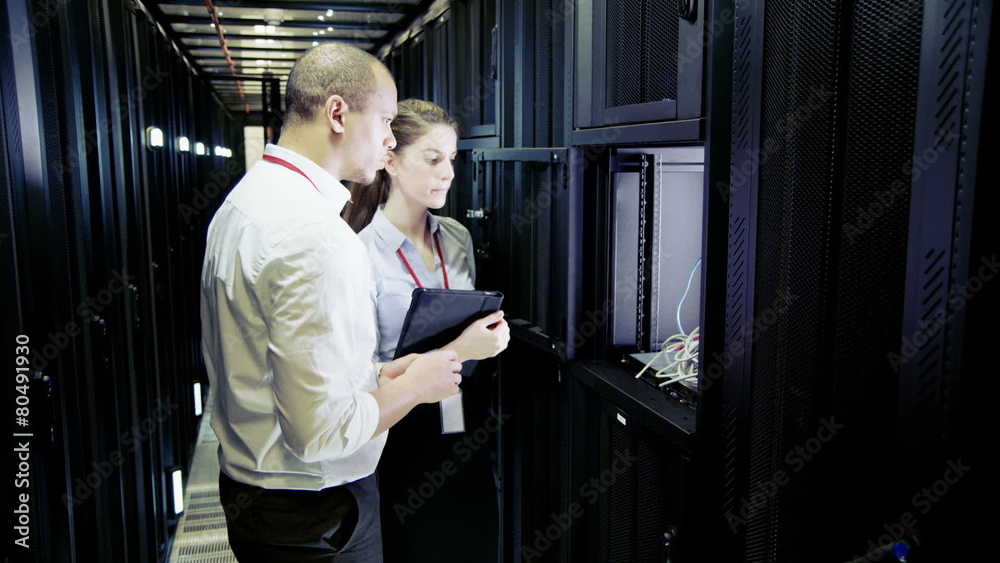 Team of IT engineers working in a data centre Team of IT engineers working in a data centre