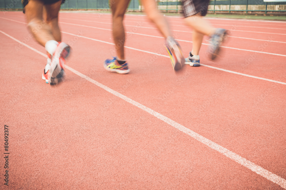 Running track with blur of runner feet in stadium Running track with blur of runner feet in stadium