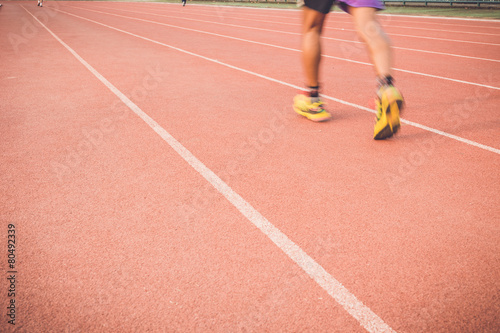Running track with blur of runner feet in stadium © SKT Studio