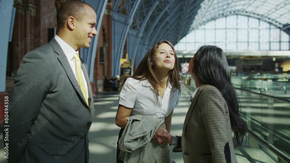 Business group meet and shake hands at London's St. Pancras railway station. Business group meet and shake hands at London's St. Pancras railway station.