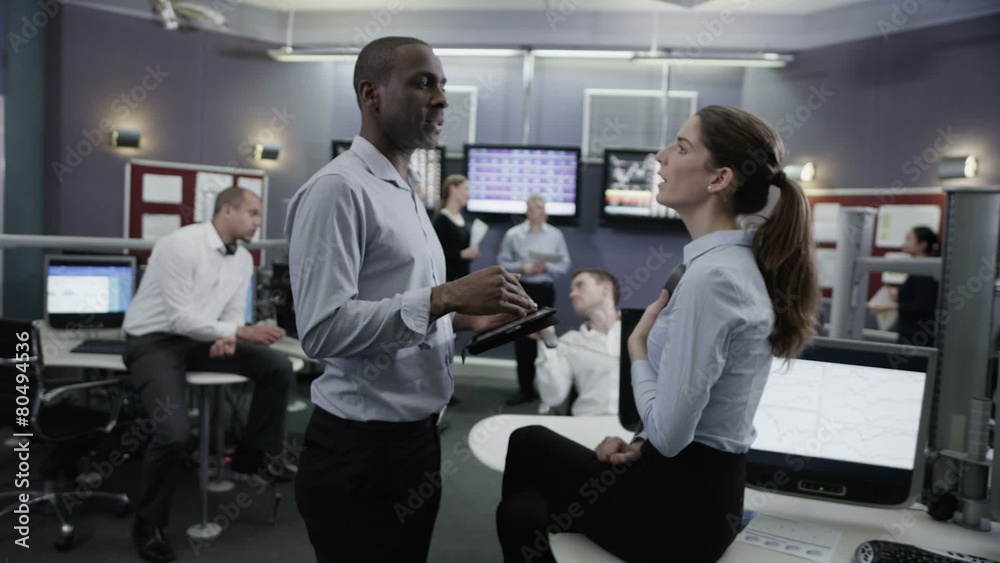 Busy team of financial traders  working together and watching the world markets