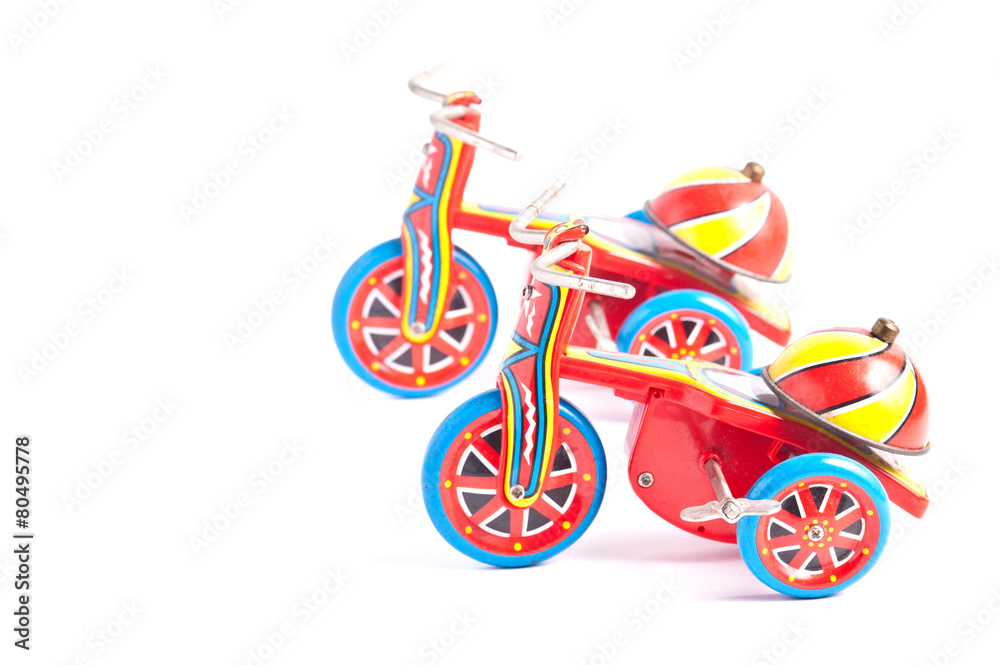 Fototapeta premium antique tin toy tricycle on white background
