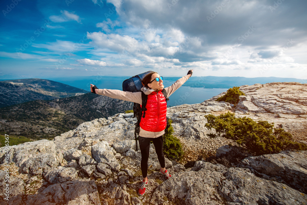 Young mountain climber on the top of island Young mountain climber on the top of island