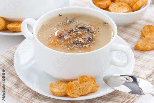 mushroom soup puree with croutons in white bowl