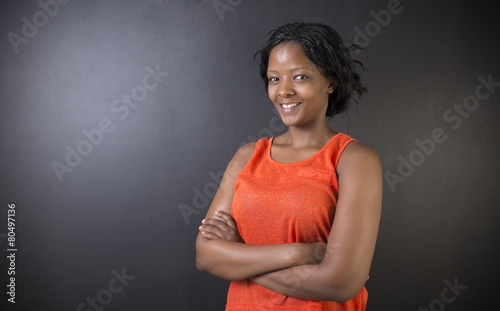African or African American woman teacher folded arms