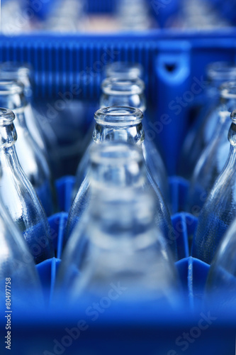 Empty bottle in blue plastic crate