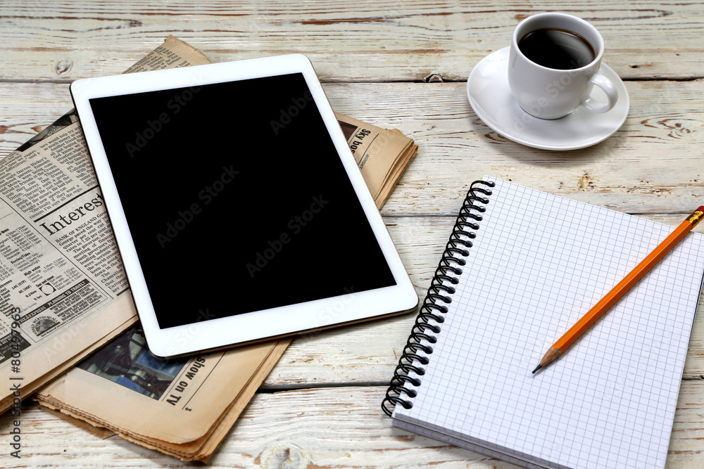 Tablet and coffee on wooden table Tablet and coffee on wooden table