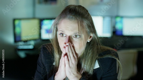 Businesswoman working late is upset by something she sees on her computer