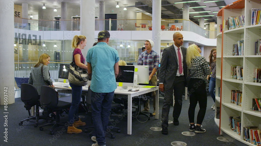 Diverse group of students in large modern university building Diverse group of students in large modern university building