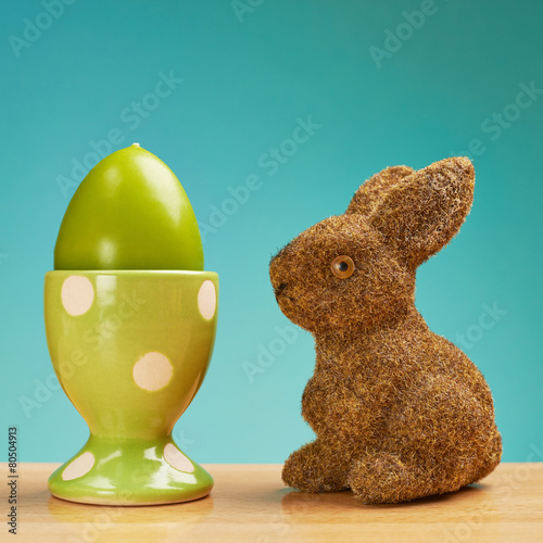 Toy rabbit next to an egg holder photo