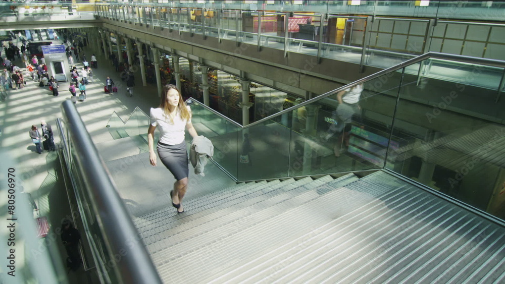 Attractive businesswoman catches the eye of flirty businessman at train station