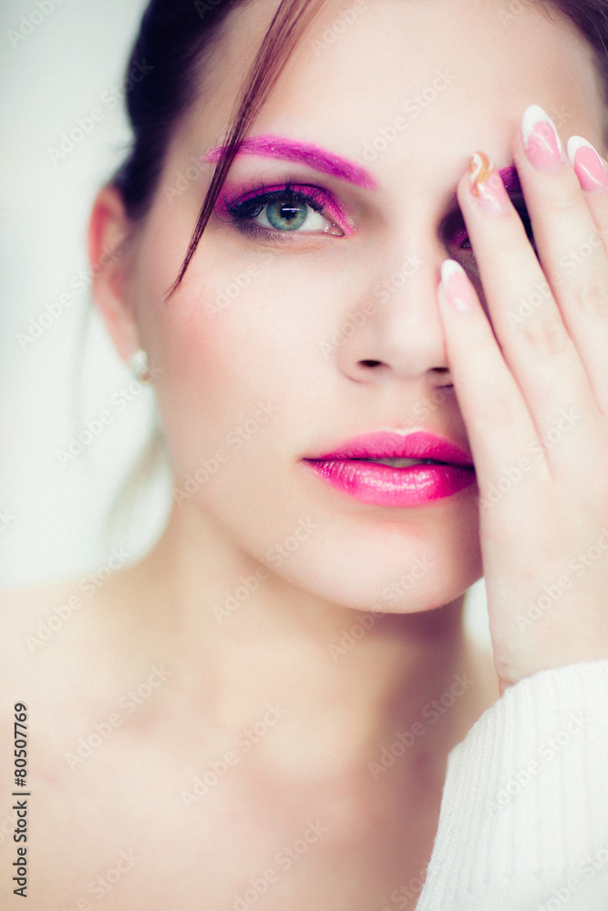 Fototapeta premium The woman with a bright pink make-up.