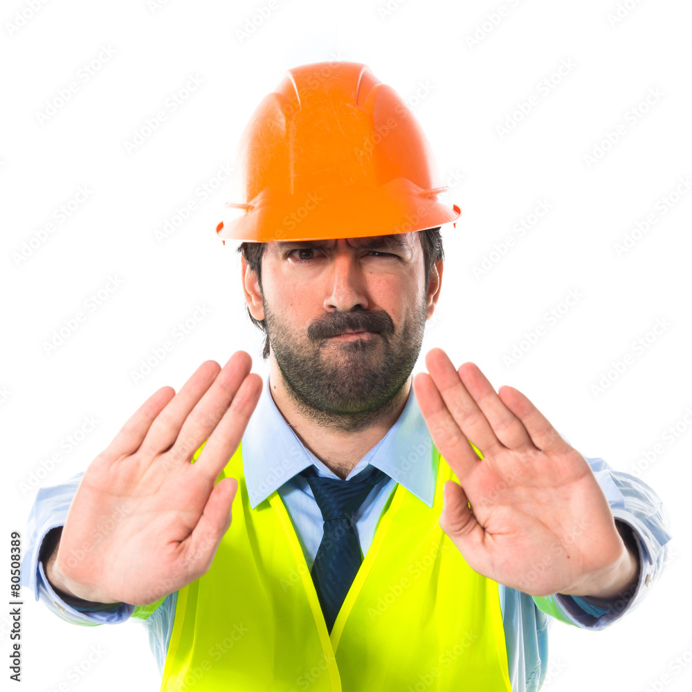 Worker making stop sign over white background Worker making stop sign over white background