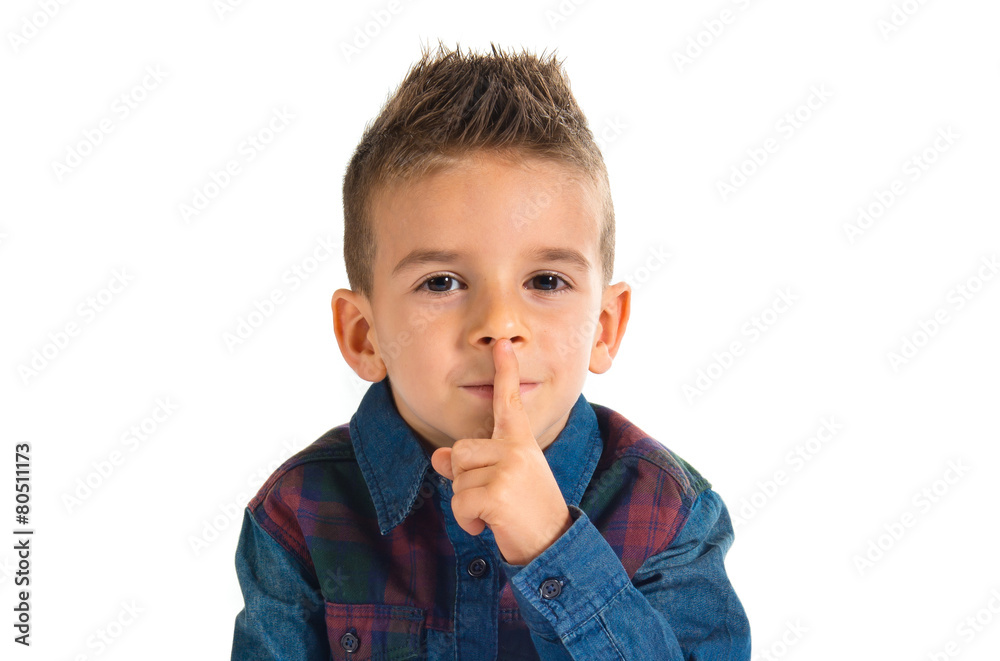 Kid making silence gesture over white background Kid making silence gesture over white background