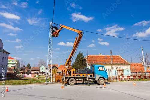 Power line team at work on a pole