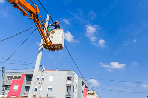 Power line team at work on a pole