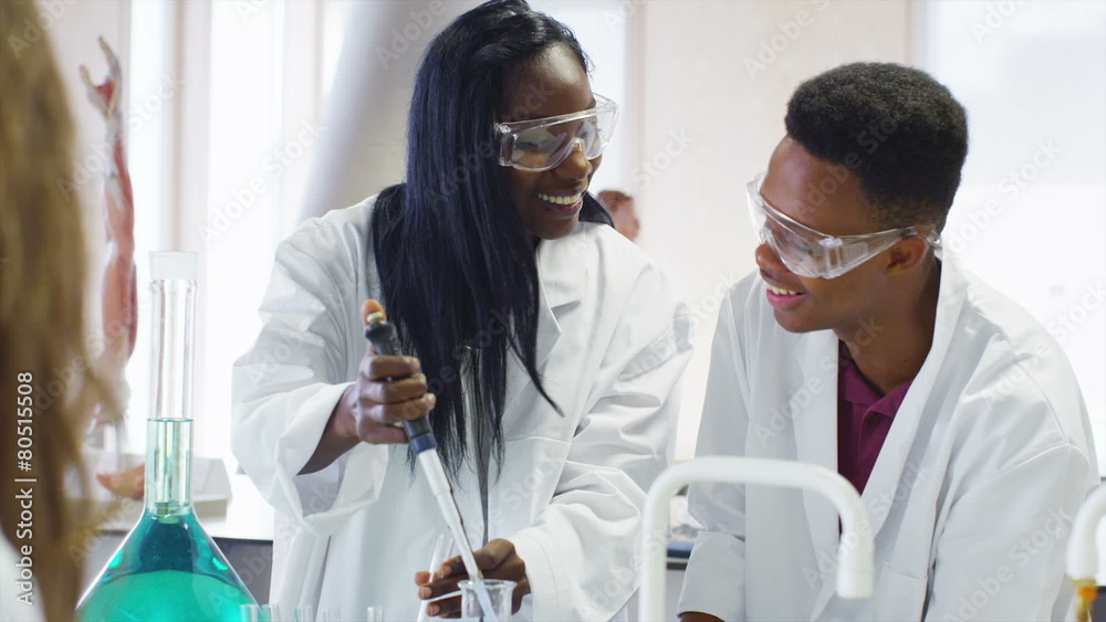 Young group of university students working together in science class