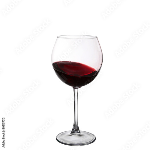 red wine swirling in a goblet wine glass, isolated on a white ba