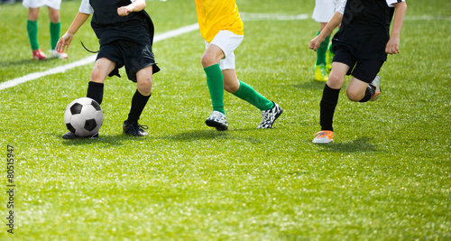 Boys playing football soccer match