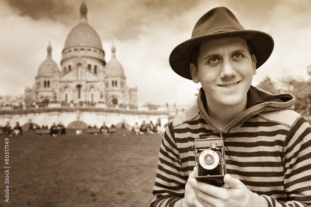 France, Paris, young man taking photograph, Sacre Coeur in backg