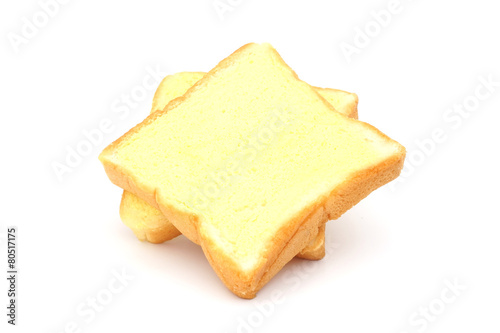 square bread with butter on white background