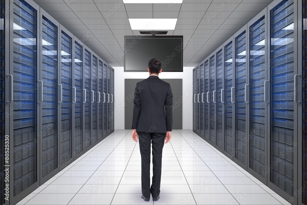 Fototapeta premium Composite image of businessman turning his back to camera