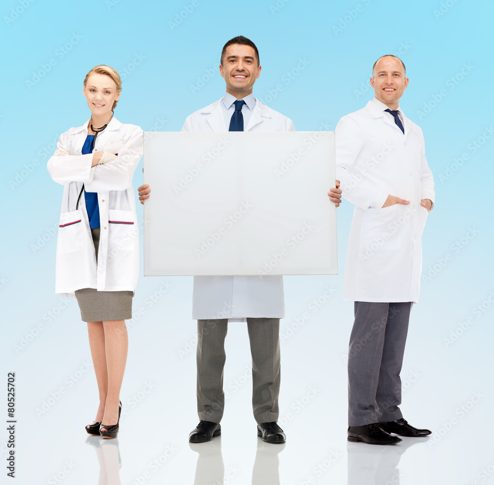 group of smiling doctors holding white blank board