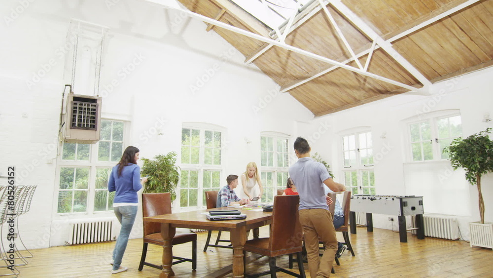 Casual business team in relaxed informal office working together on a project Casual business team in relaxed informal office working together on a project